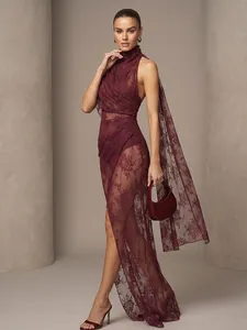 Detailed view of an elegant burgundy lace long dress with a high neck and flowing cape.