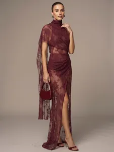 Close-up detail view of burgundy sheer floral lace maxi dress with high neck and side slit