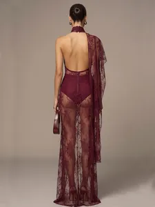 Detail view of the backless design and sheer lace fabric of this elegant burgundy maxi dress