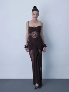 Detailed view of elegant brown lace maxi dress with hollowed waist and draped knot detail.