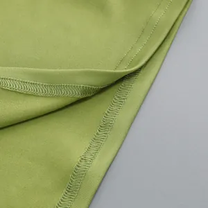 Detalle macro de vestido verde aguacate con costura de dobladillo de calidad