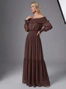 Foto de estudio que muestra el largo de un vestido largo marrón con hombros descubiertos