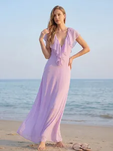 Elegant lavender deep V-neck maxi dress with ruffles shown on a scenic summer beach sunset