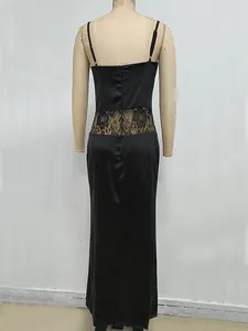 Back view of elegant black camisole dress with lace patchwork detail on mannequin