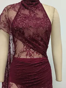 Detailed view of the intricate burgundy floral lace texture on a sexy bodycon maxi dress