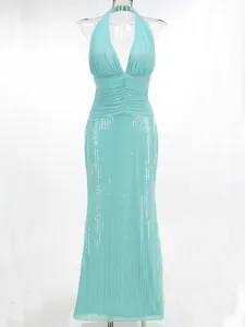 Detalle de un vestido largo turquesa con cuello halter, escote en V profundo y lentejuelas