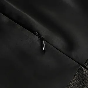 Macro view of hidden back zipper and lace detail on a black elegant dress