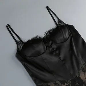 Detail of black satin camisole dress featuring elegant lace trim and slim straps