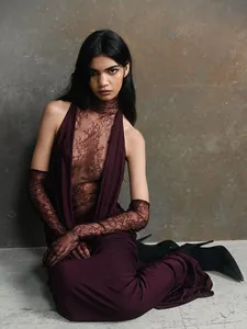 Elegant burgundy halter evening gown with sheer lace details and matching gloves.