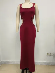 Vestido largo rojo ajustado en maniquí con sexys aberturas y detalles de lentejuelas.