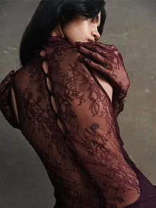 Detailed view of burgundy lace patchwork evening dress with back button closure