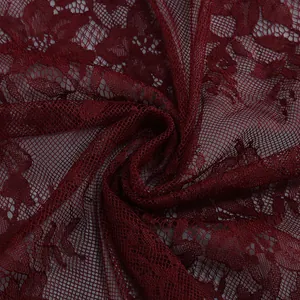 Close-up macro detail of elegant wine red floral lace fabric with fine mesh texture