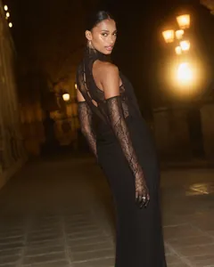 Detailed view of the back lace patchwork and halter neck on a black evening gown at night