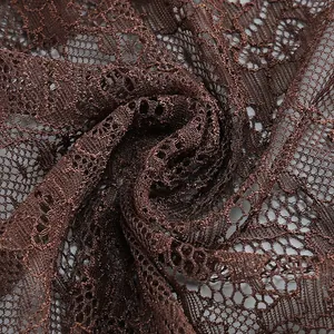 Detailed macro view of elegant brown floral hollow lace fabric texture for evening dress