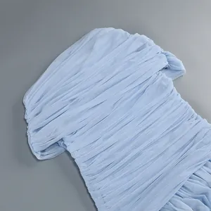 Close-up detail of the elegant ruched mesh fabric on this light blue one-shoulder maxi dress.