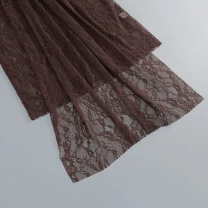 Close-up detail of the intricate brown floral lace fabric and delicate hollow-out pattern