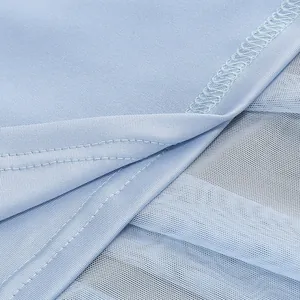 Macro detail view of light blue mesh dress showing fine stitching and soft fabric texture