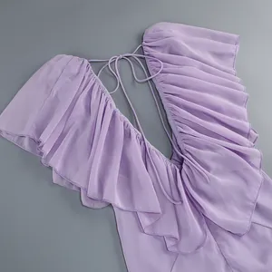Detail of lavender deep V-neck dress with elegant ruffle trim and tie-back design