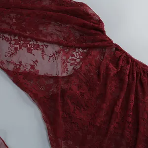 Close-up detail showing the intricate floral lace texture of a wine red vacation dress
