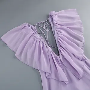 Close-up of lavender deep V-neck dress with ruffles and backless tie-up details.