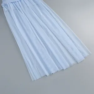 Detailed view of the light blue pleated tulle mesh fabric of the long dress