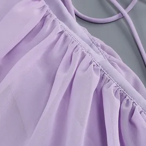 Close-up of light purple chiffon fabric with fine pleats and delicate strap.