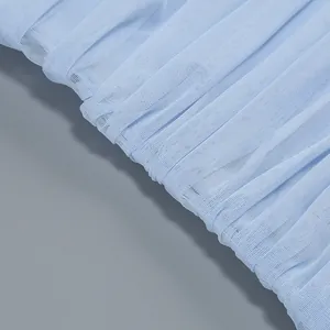 Close-up of light blue pleated mesh fabric showing fine texture of summer dress detail.