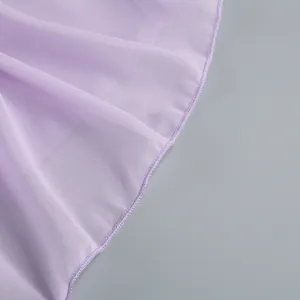 Close-up of lightweight lavender chiffon fabric showing a delicately stitched hemline