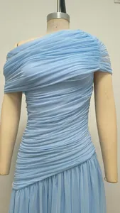 Detailed macro view showing the ruched light blue one-shoulder mesh maxi dress texture