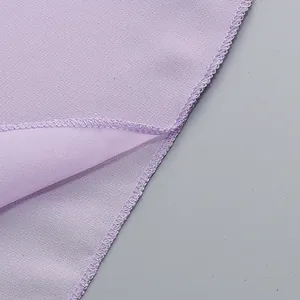 Detailed close-up showing neat overlock stitching on a lavender evening dress hem