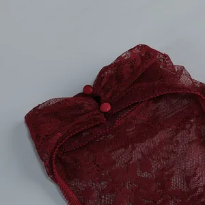 Detailed macro shot of wine red floral lace fabric and buttons on a sexy dress