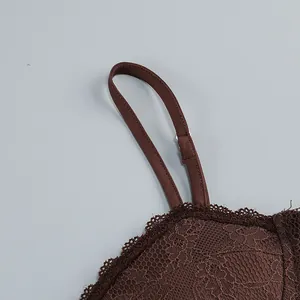 Detailed view of the adjustable thin strap and elegant brown floral lace on dress