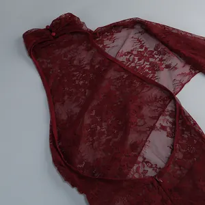 Close-up detail of the elegant burgundy lace dress showing intricate mesh embroidery.