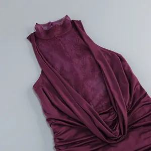 Macro detail view of burgundy halter neck dress with lace insert and draped neckline