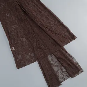 Detailed view of the intricate brown hollow-out floral lace fabric for party dress.