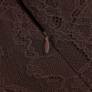 Detailed view of the brown lace fabric texture and concealed zipper on an evening dress