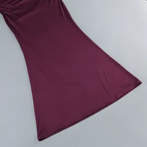 Detailed macro view of plum purple dress skirt showcasing soft pleated fabric texture