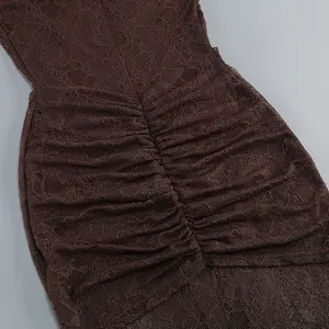 Detail of brown floral lace fabric with elegant ruching on bodycon dress