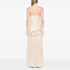 Elegant back view of a champagne pleated strapless evening gown with ruffle details