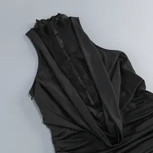 Close-up detail of black halter dress featuring sexy lace patchwork and elegant draping