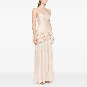 Elegant strapless champagne evening gown featuring a pleated bodice and layered ruffle waist