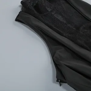 Detail shot of the side zipper and lace patchwork on a black sexy evening dress
