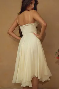Detalle posterior de un vestido amarillo pálido de estilo francés con tirantes y dobladillo fluido