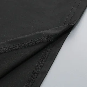 Macro view showing the high-quality stitching and seam details on black evening dress fabric.