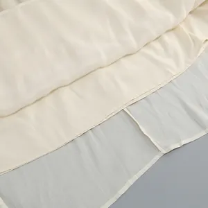 Detailed macro view of elegant cream evening dress fabric featuring a smooth inner lining