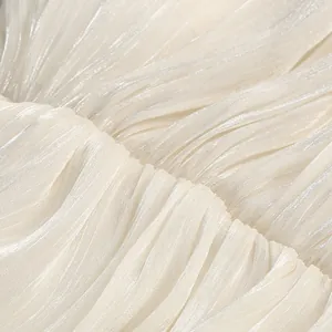 Close-up of elegant pleated fabric with pearlescent shimmer for evening dress detail