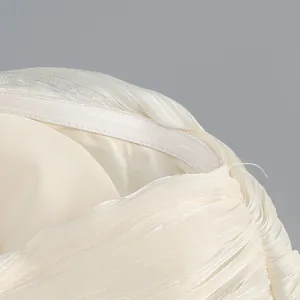 Close-up detail of elegant cream pleated evening dress neckline with anti-slip silicone strip