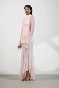 Detail of a pink asymmetrical high neck dress with elegant ruched texture and mesh sleeves.