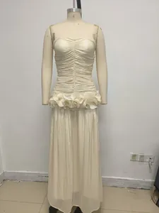 Elegant cream strapless evening gown featuring ruffled waist detailing on a mannequin display