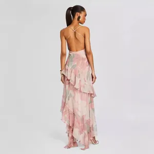 Back view of elegant pink floral backless maxi dress featuring tiered ruffles and spaghetti straps